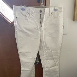 Women’s white skinny jeans with distressed bottoms